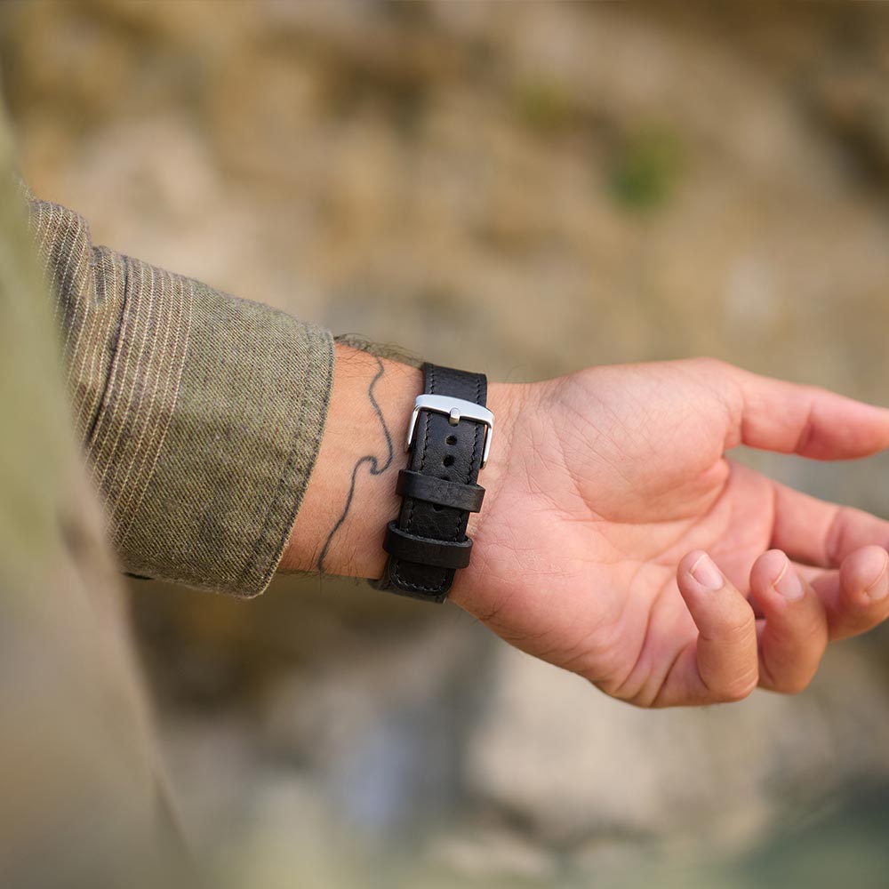 Mann trägt zeigt den Verschluss seiner Armbanduhr von Goodwilhelm
